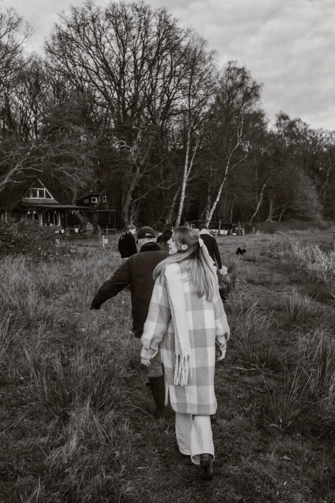 Vrouw loopt achter familie aan door hoge grassen aan de Regge